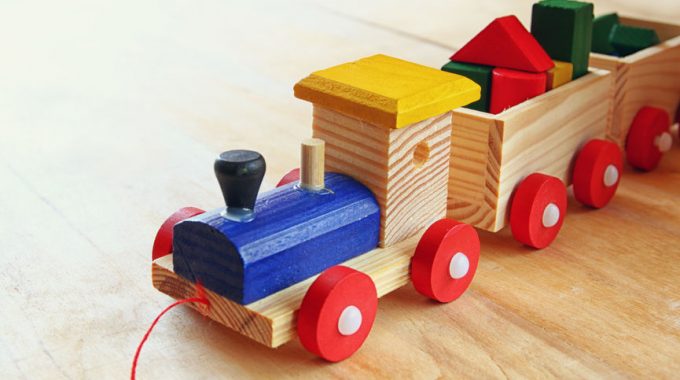 Close Up Of Wooden Toy Train Over Wooden Table. Selective Focus. Retro Filtered