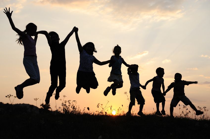 Silhouette, Group Of Happy Children Playing On Meadow, Sunset, Summertime